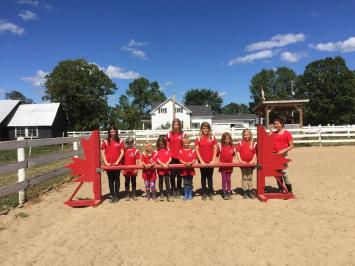 Posing in front of jumping bar during camp at Preston Rosedale Farm